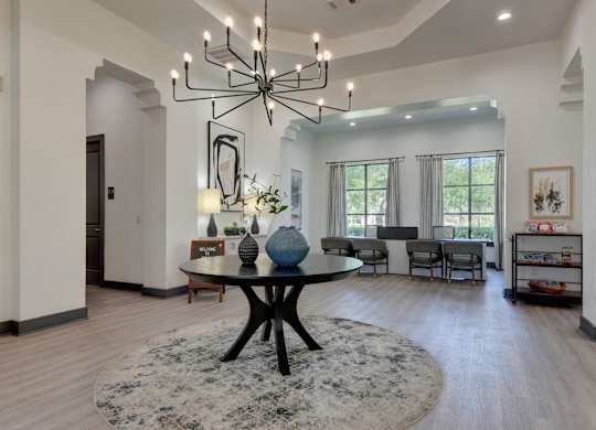 A modern dining room with a large table and chairs.