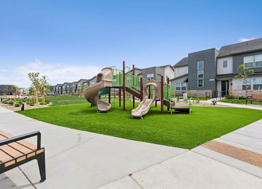 A playground with a slide and a bench.