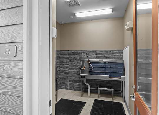 A bathroom with a tiled wall and a shower stall.