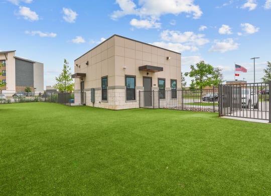 the preserve at ballantyne commons office building with a green lawn and a fence