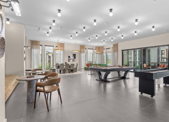 a large room with a pool table and tables in it