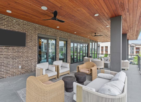 a lounge area with couches and chairs and a television