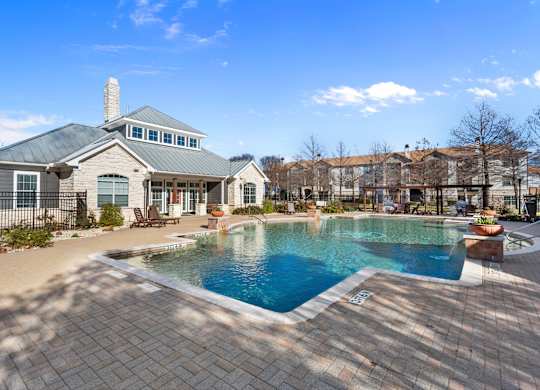 A large house with a pool in the backyard.
