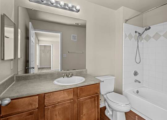 A bathroom with a white toilet, sink, and bathtub.