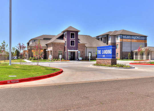 The Landing OKC is a beautiful apartment complex with a clear blue sky in the background.
