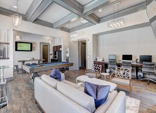 A modern living room with a pool table and a television.