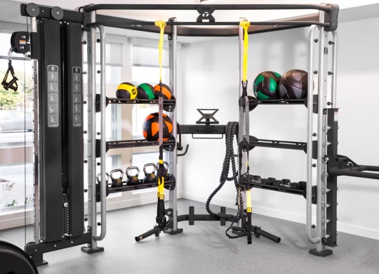 a home gym with weights and other gym equipment in it
