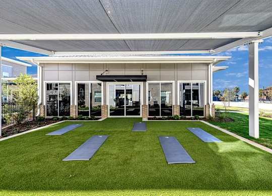 A yoga studio with a white roof and a glass wall.
