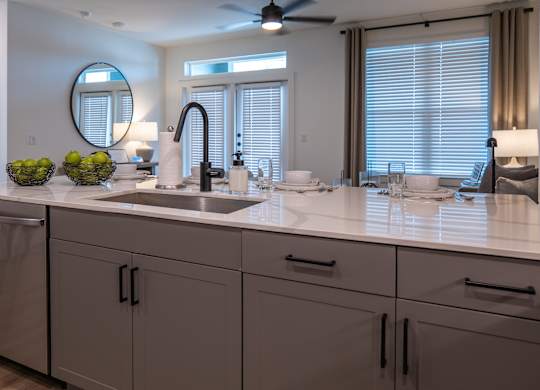 A modern bathroom with a large mirror and a sink.