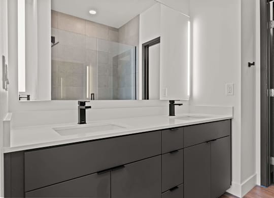 A bathroom with a white sink and a mirror above it.