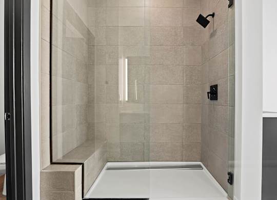 A modern bathroom with a walk-in shower.
