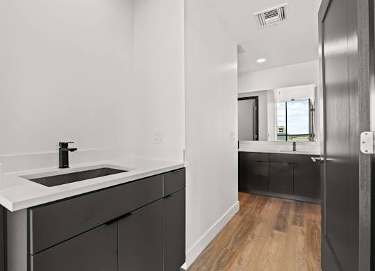A modern bathroom with a black and white color scheme.