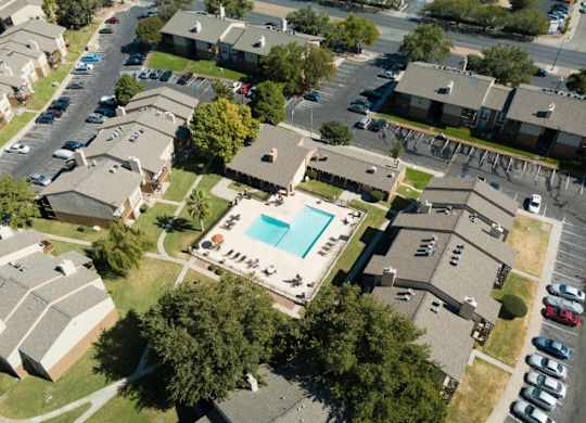 an aerial view of a neighborhood of houses and a swimming pool