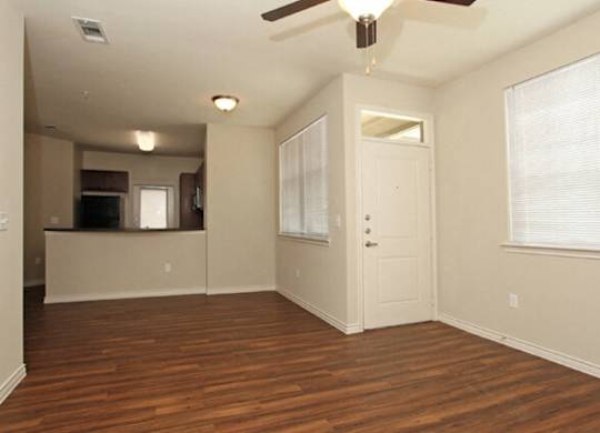 vacant apartment living room and kitchen in background