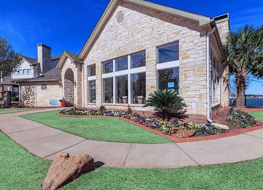 A house with a stone facade and a large front yard.