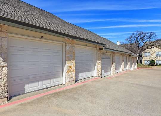 A row of garage doors are closed and numbered 21 to 23.