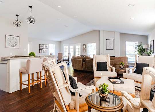 A living room with a white couch and a coffee table.