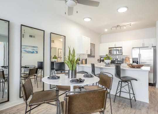 a dining room and kitchen with a table and chairs