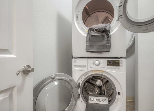 a washing machine and dryer in a small laundry room
