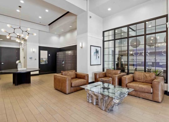 a large lobby with leather couches and a glass table