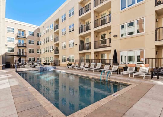 a swimming pool in front of an apartment building