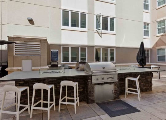 a patio with a bar and a grill