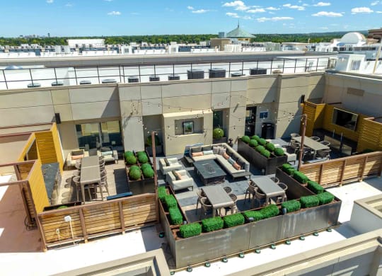 a rendering of a rooftop patio with tables and chairs
