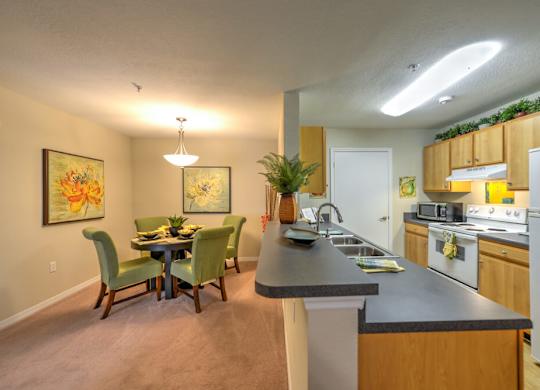 A kitchen with a dining table and chairs.