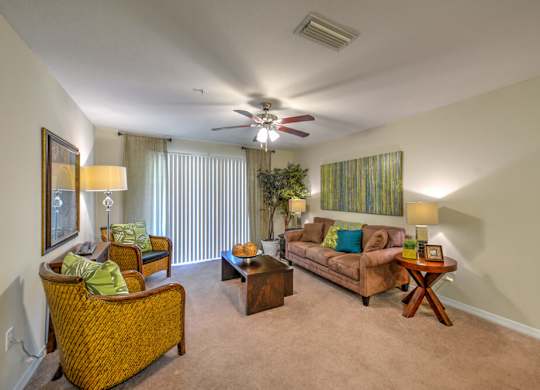 A living room with a brown couch, a chair, and a coffee table.