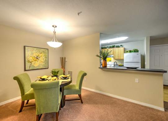 A dining room with a table set for four.