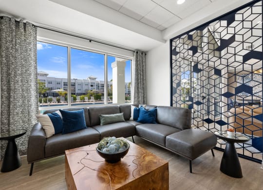 a club house lounge area with a couch and a table