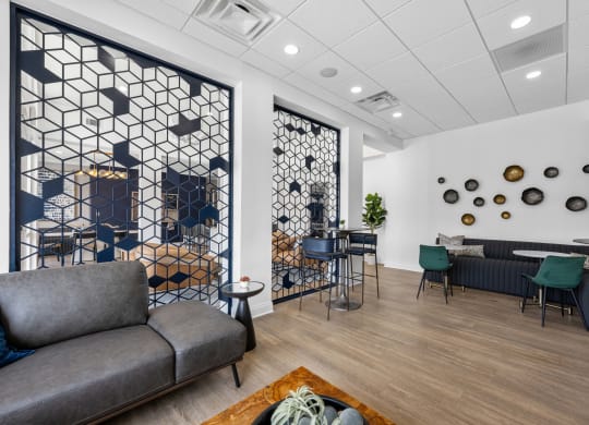 a lounge area with couches and chairs and a table with chairs in a lobby
