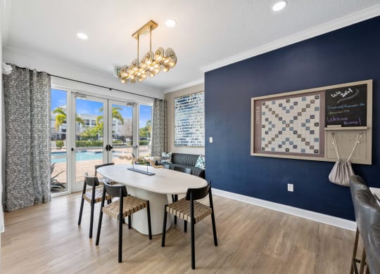 a dining room with a table and chairs and a chandelier