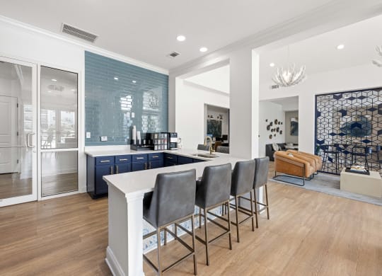 a communal kitchen with a white counter top and blue cabinets