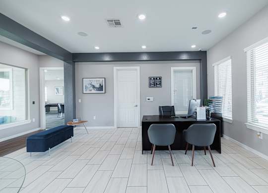 A modern office with a desk and chairs.