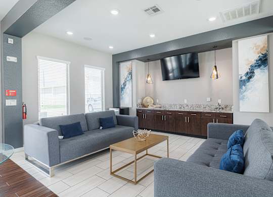 A living room with a grey couch and a wooden coffee table.