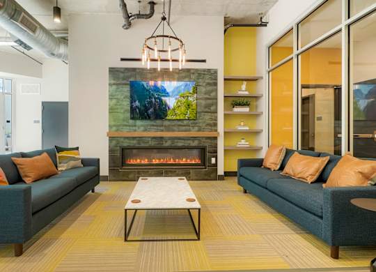 A modern living room with a fireplace and a television mounted above it.