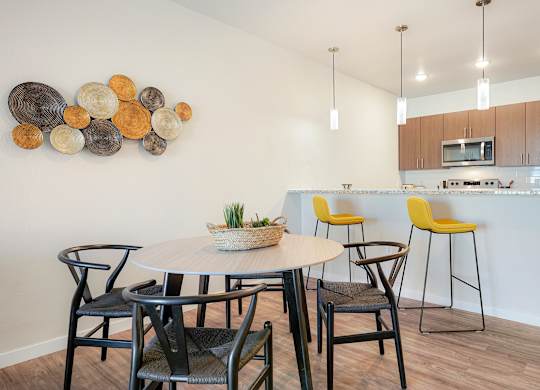 A modern dining room with a round table and chairs.