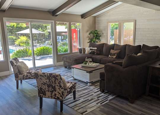 a living room with a couch and chairs and a table