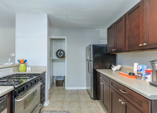 a kitchen with wood cabinets and stainless steel appliances