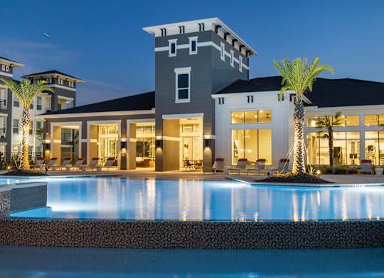 A modern house with a pool in front.
