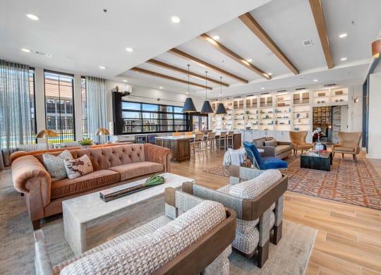 a living room with couches and chairs and a bar