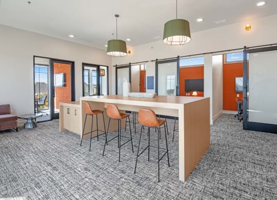 an open office space with a large counter and chairs