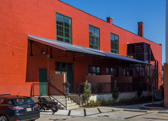 a red brick building with a blue awning in front of it
