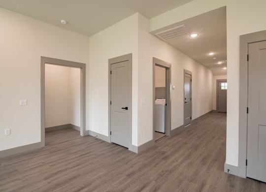 A long hallway with doors on both sides.