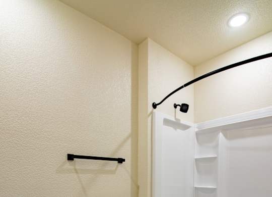 A white toilet sits next to a bathtub in a bathroom.