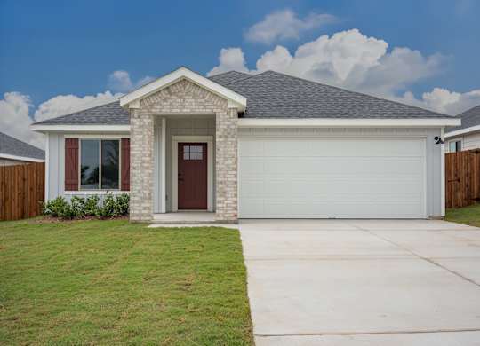 A house with a brown door and a grey roof.