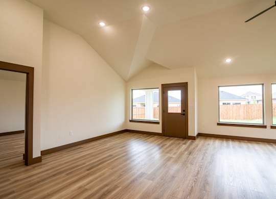 A room with wooden floors and a ceiling fan.