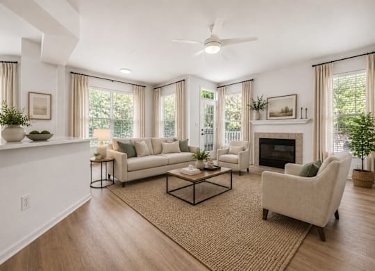 A living room with a fireplace, couch, and plants.