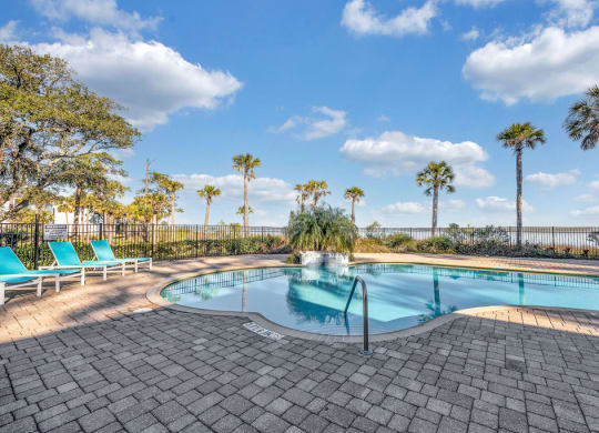 a swimming pool with palm trees in the background